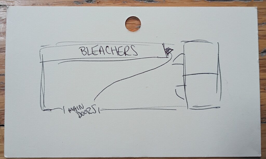 A map of a gym with an arrow going under the bleachers